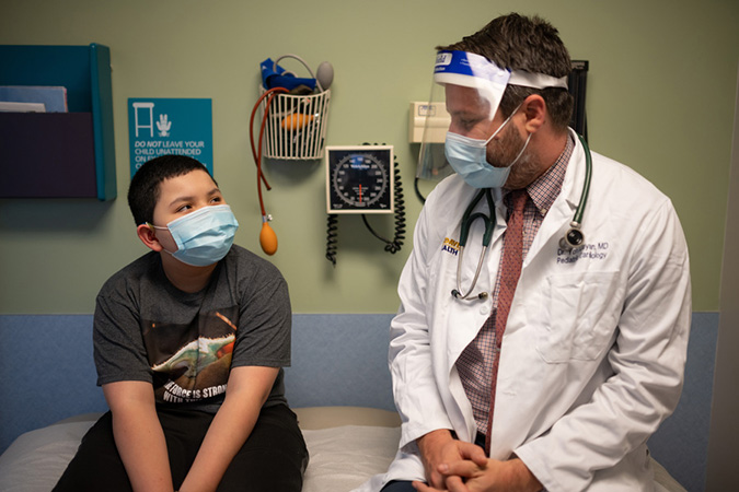 Doctor smiling with pediatric patient