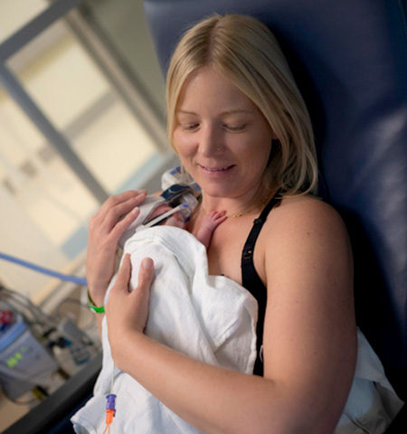 Katherine Marlin holding her baby Cade who was born preterm. Cade has higher protein needs in his diet, so he got protein-fortified breast milk.