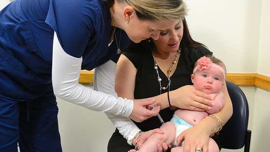 Nurse positioning a baby