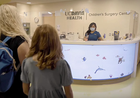 Mom with daughter walking to reception area