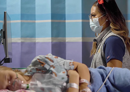 Patient in post-surgery recovery room with nurse