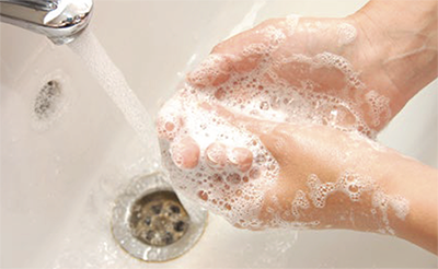Washing hands with soap in a sink