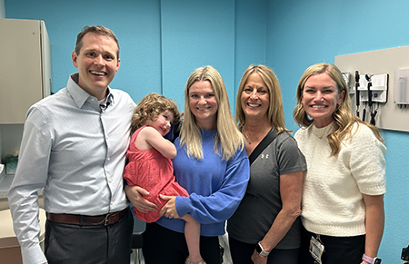 Brian Goudy with child, child's mom and grandma and nurse Callie Brecek