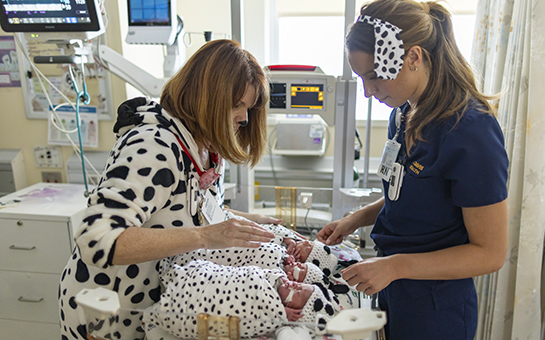 Nurses with babies dressed up as dalmatians