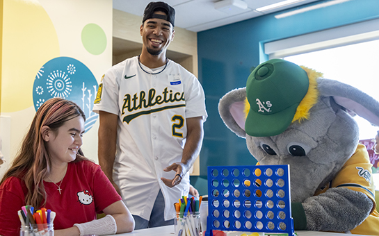Patient with Athletic A’s player and mascot