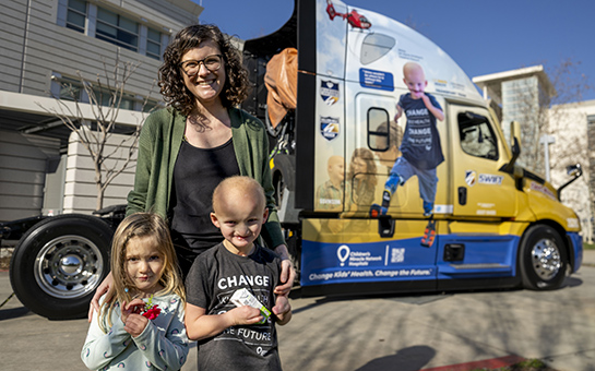 Shine Duby with his family posing with a semitruck