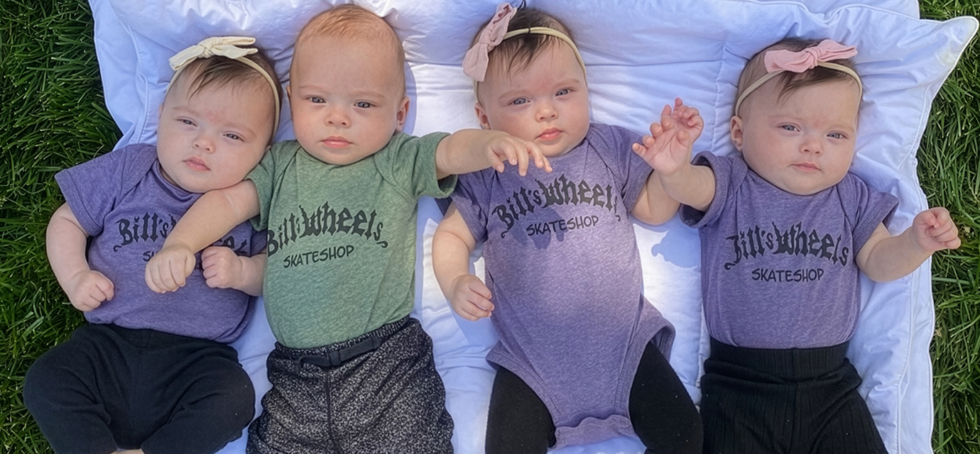 Delgado quadruplets laying on a blanket