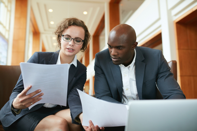 Professional man and woman looking at papers. 