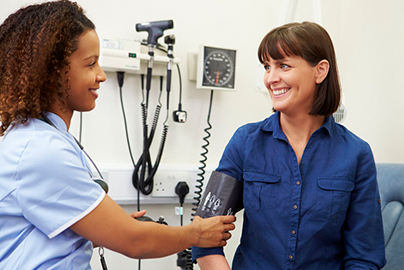 Doctor taking patients blood pressure. 