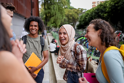 A group of college kids talking and laughing. 