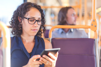 Person using a smartphone while seated on public transit.