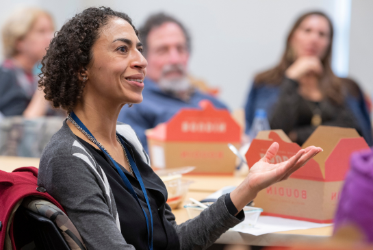 Alicia Agnoli, associate professor at UC Davis, wearing a grey coat speaks while seated.