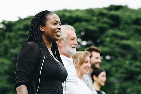 people in a group outside smiling