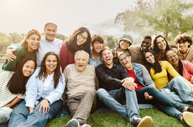 group of diverse people smiling together in a park