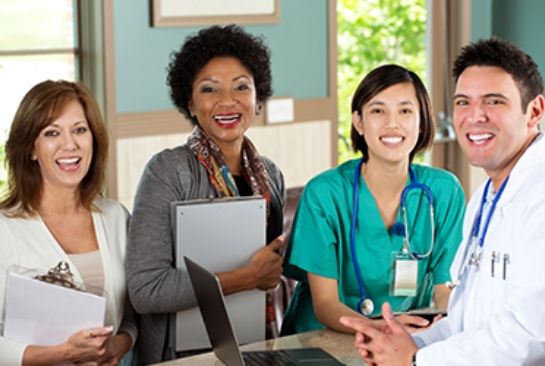 group of doctors and nurses smiling at camera