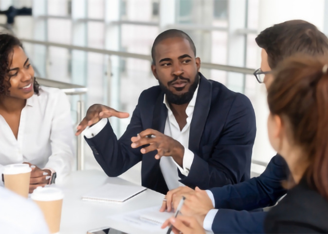 business people sitting around a table talking