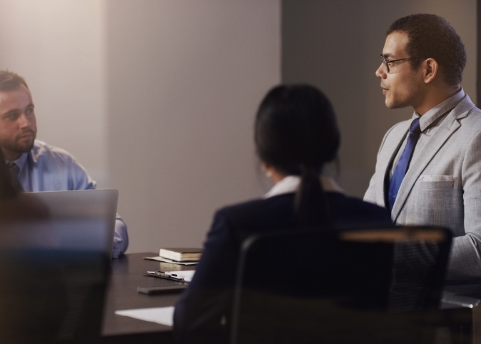 people at a meeting sitting around a table