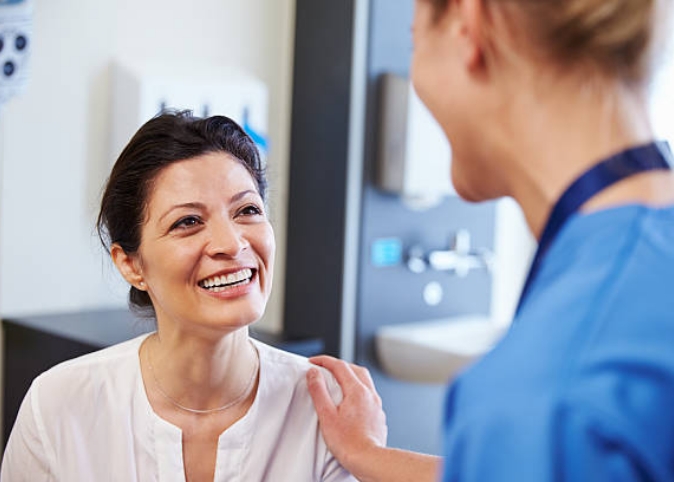 doctor talking to patient in exam room