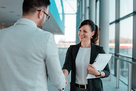 Woman shaking hands (C) Adobe Stock. All rights reserved.