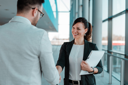 Woman shaking man's hand (C) Adobe Stock. All rights reserved.