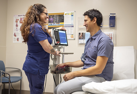 Male patient having his blood pressure taken in a cardiology clinic.