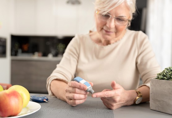 Mature woman testing her blood sugar