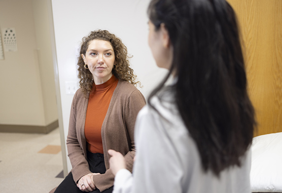 Woman speaking with her health care provider about endocrine tumor syndromes.