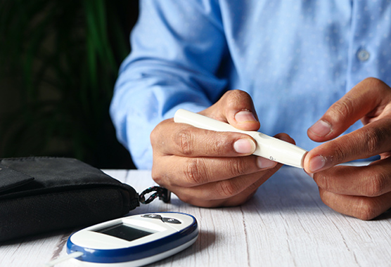 Close up on person’s hands using a glucose monitor