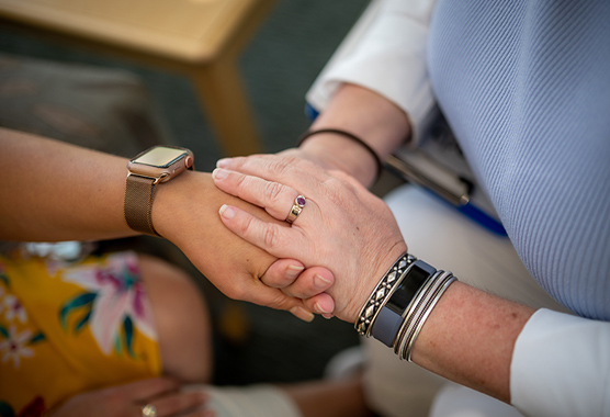 Cancer patient holding hands.