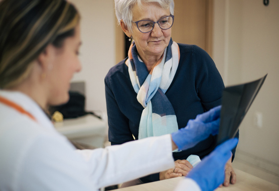 Patient and physician looking at images discussing metabolic bone disease.