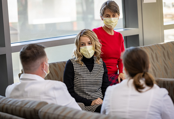 Female cancer patient talking to health care providers.