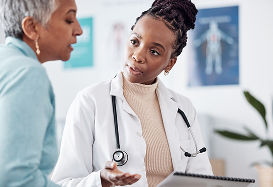 Female provider speaking with female patient about neuromuscular disorders.
