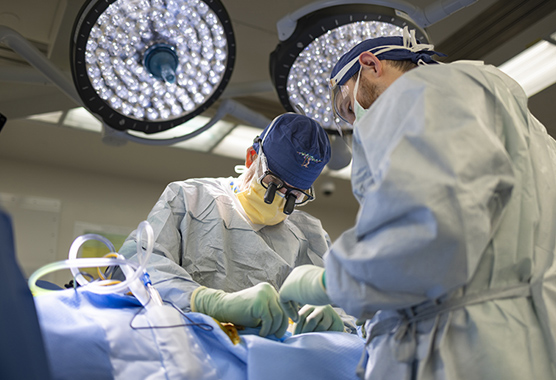 Orthopaedic surgeon performing surgery on patient with a provider assisting him.