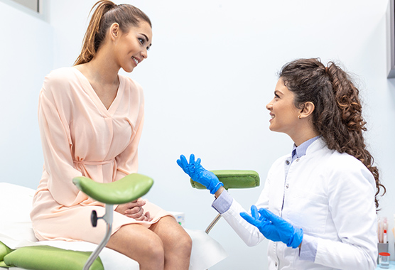 Woman in an OBGYN office with a female healthcare worker