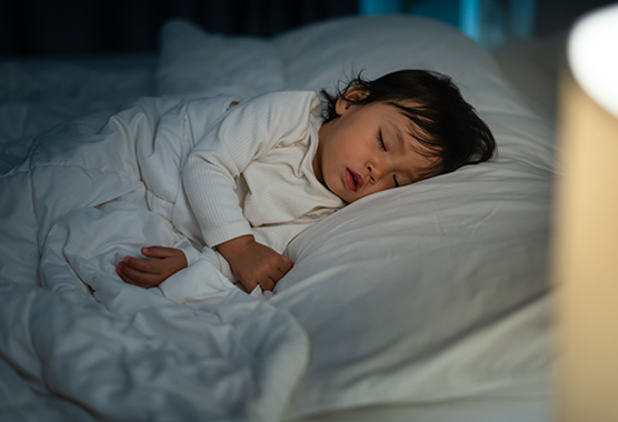Child sleeping in a bed.