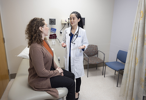 Female health care provider talking to female patient about yeast infection.