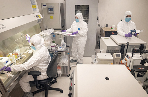 Three people working in a lab