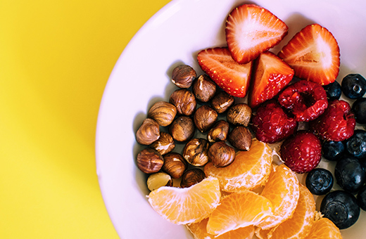 Snack plate with various fruits and nuts.