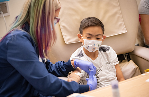 Young patient receiving treatment in a hospital bed.