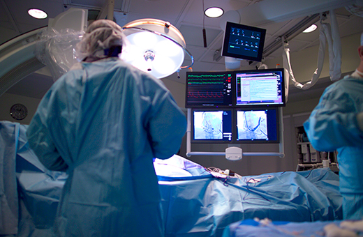Colorectal surgeons operating on patient in operating room.