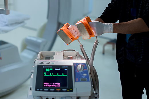 Close-up of a doctor holding defibrillation paddles