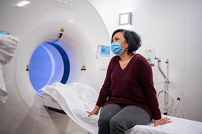 Female patient with comfortable clothes speaking to a physician before her scan