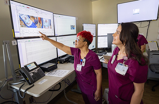 Health care providers monitoring patient’s EEG test.