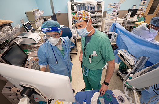 Surgeons looking at screen during epilepsy surgery.