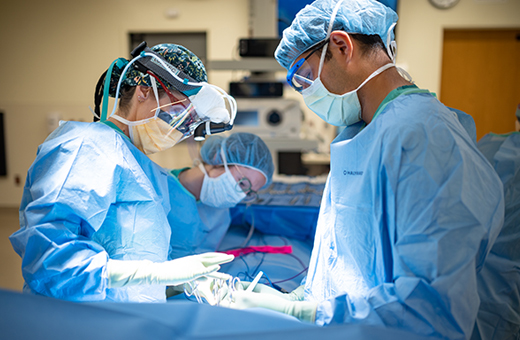 Surgeons performing surgery on a patient.