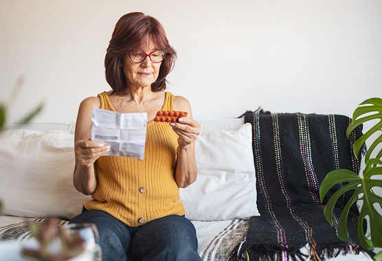 A woman holding products for hormone replacement therapy.