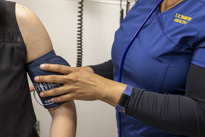 Nurse taking blood pressure of a patient