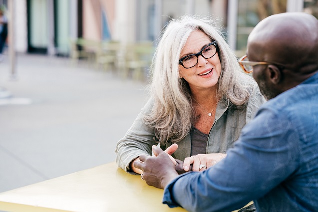 Woman and man talking at a table