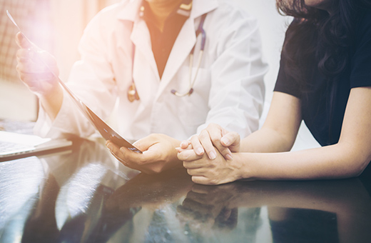 Close-up of a doctor and patient looking at scans