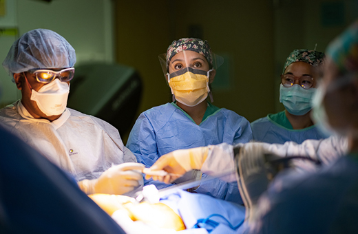 Surgeons performing lung cancer surgery in operating room.